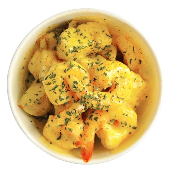 Louisiana Shack's cajun shrimp in a creamy yellow sauce, garnished with parsley and spices.